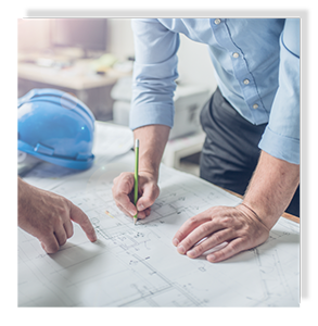 People drawing and pointing to blueprints on a table