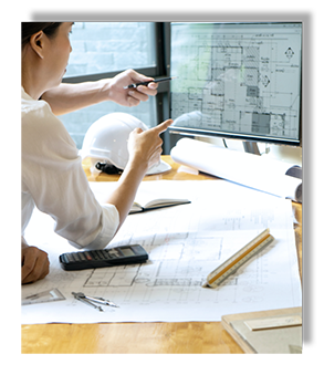 Woman discussing blueprints on computer screen with colleague