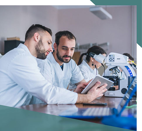 Lab workers reviewing together on a tablet