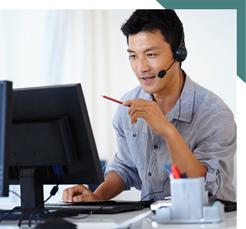 Man in headset in front of computer